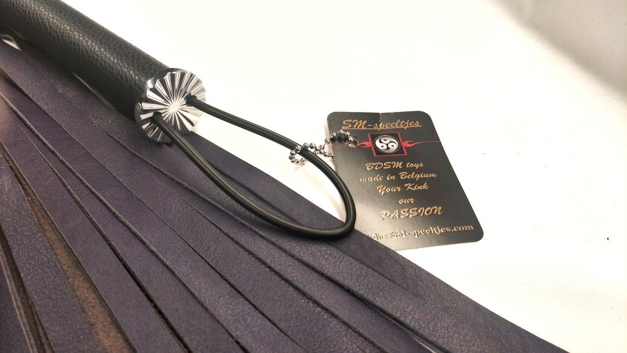deze-paars-lederen-flogger-met-onderaan-d-ringen-aan-bevestigd-zal-je-bdsm-toy-collectie-net-weer-iets-uitgebreidr-en-exclusiever-maken-4