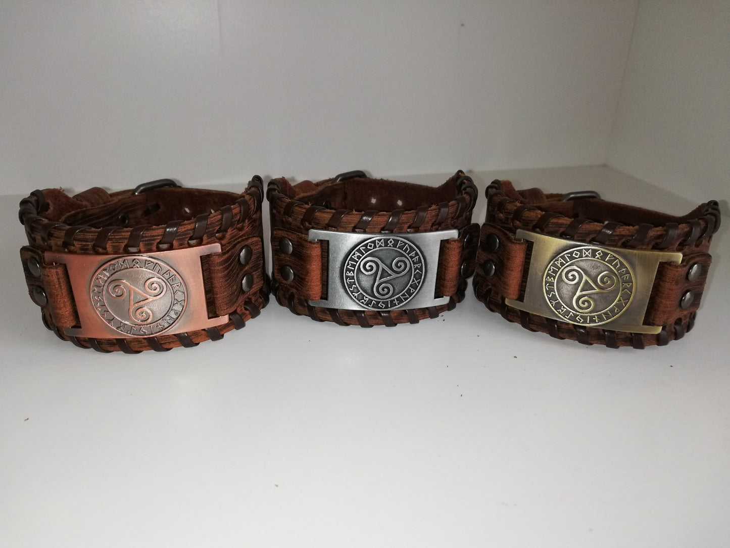 Brown leather bracelet with gold colored BDSM logo