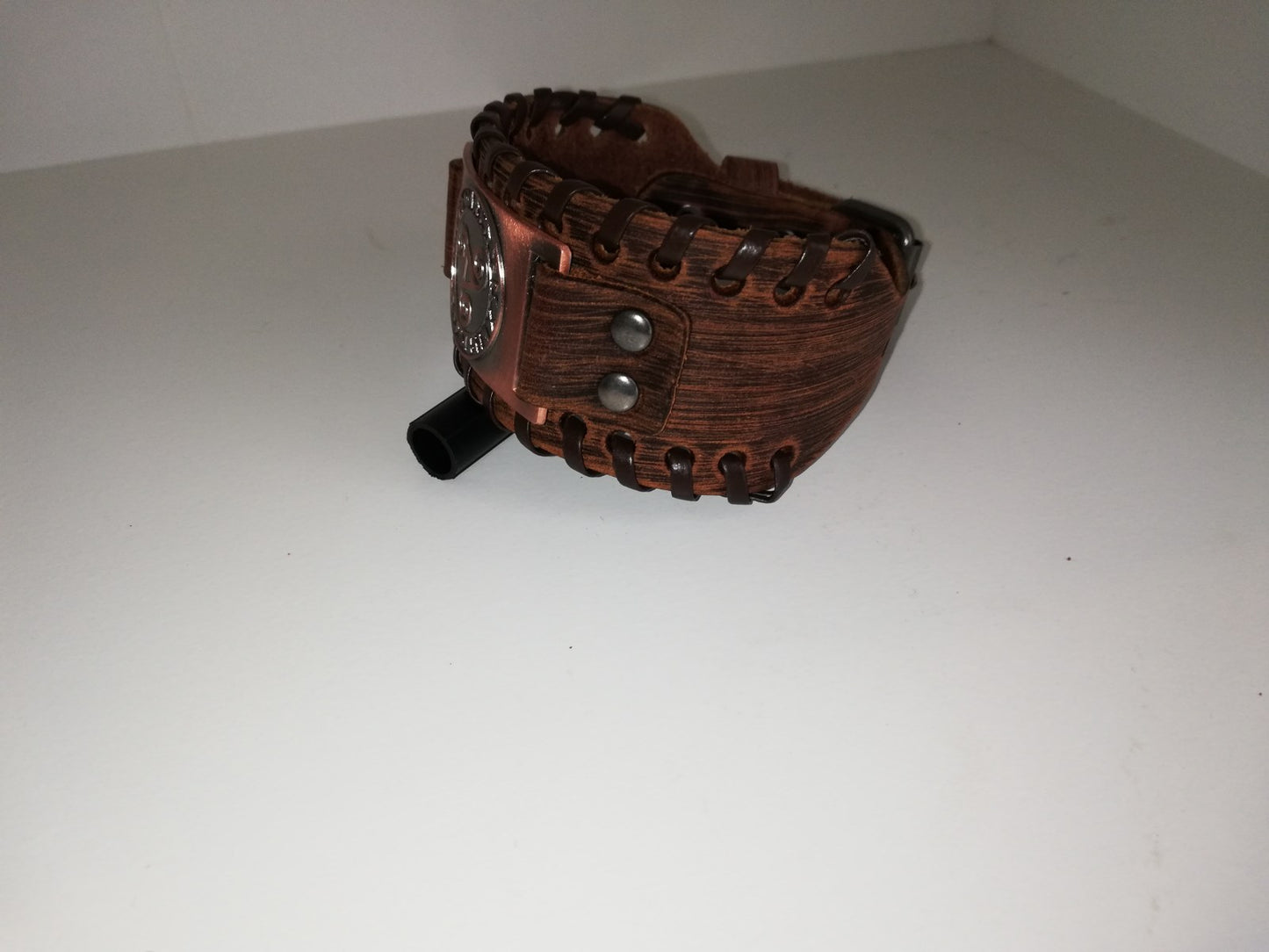Brown leather bracelet with bronze colored BDSM logo