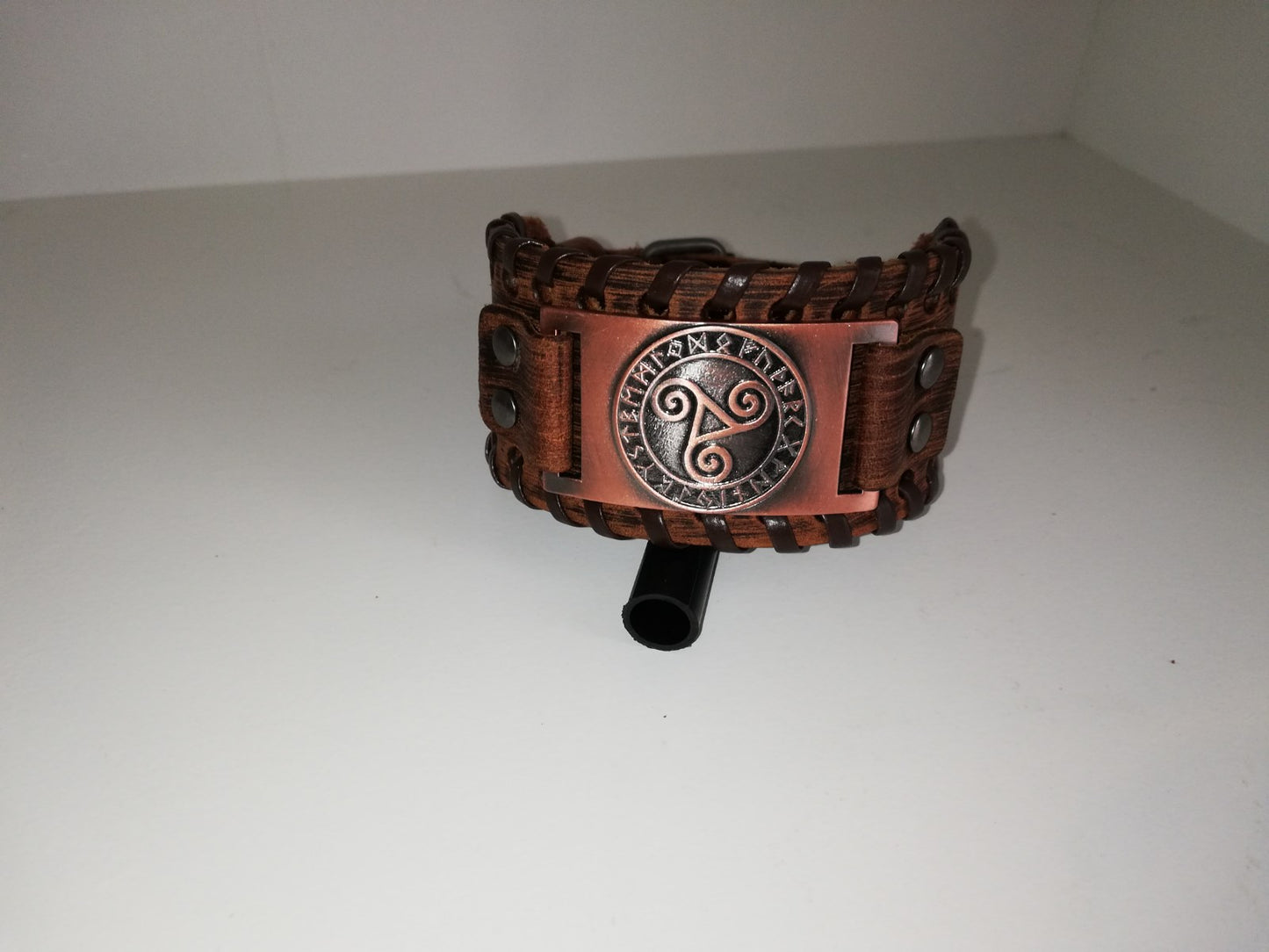 Brown leather bracelet with bronze colored BDSM logo
