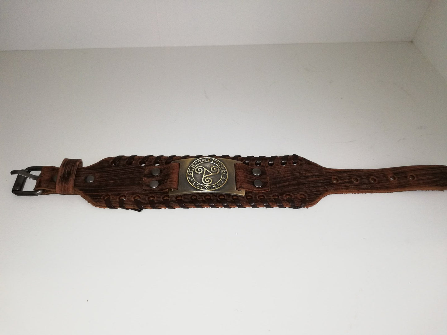 Brown leather bracelet with gold colored BDSM logo