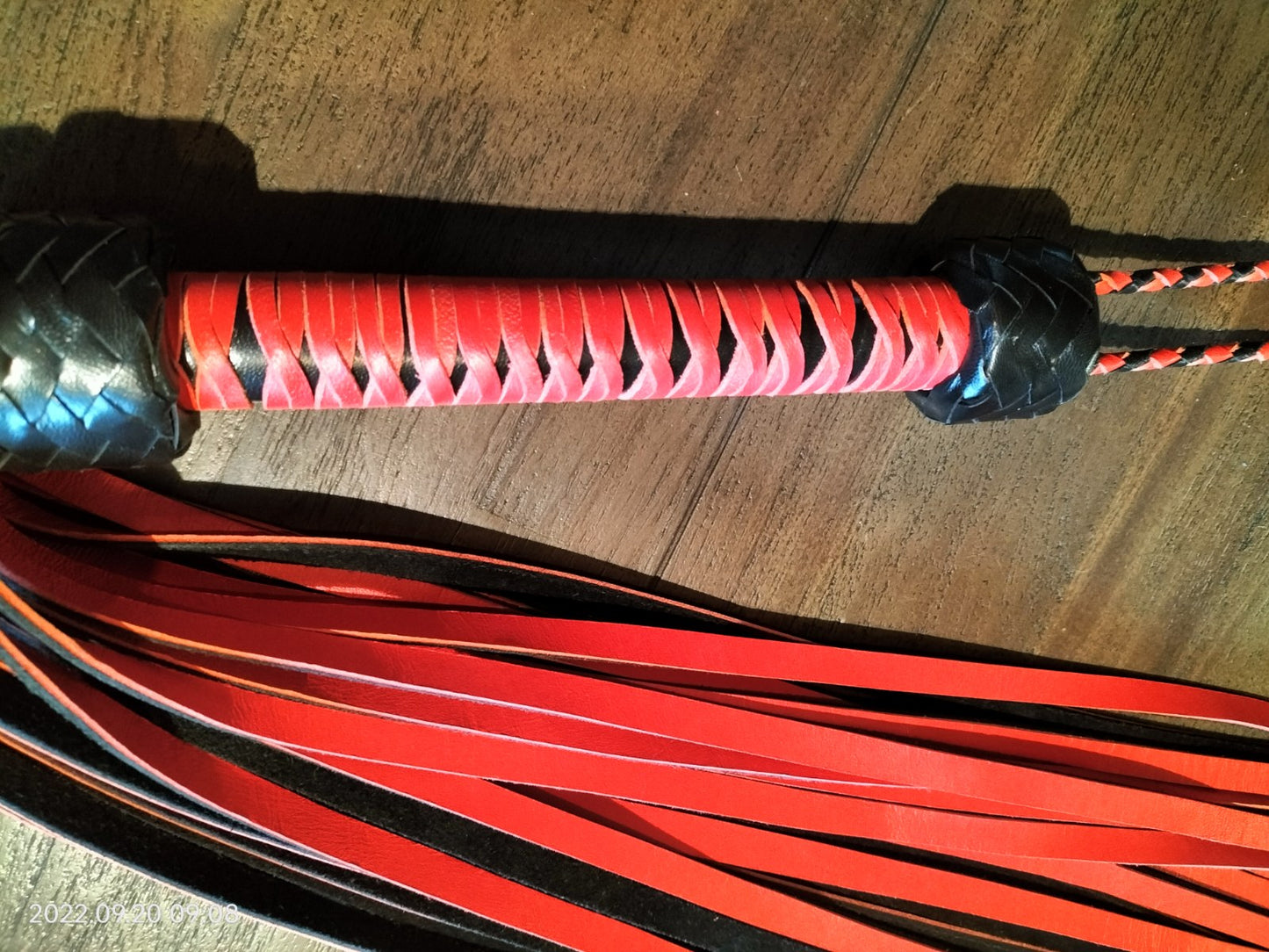 Heavy red/black flogger with red woven handle